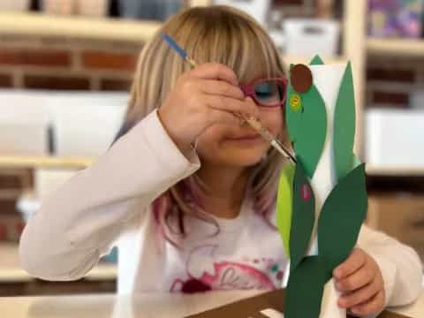 a girl with a green toothbrush