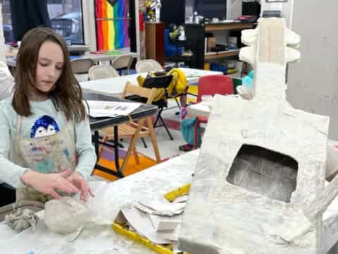 a person painting a large stone
