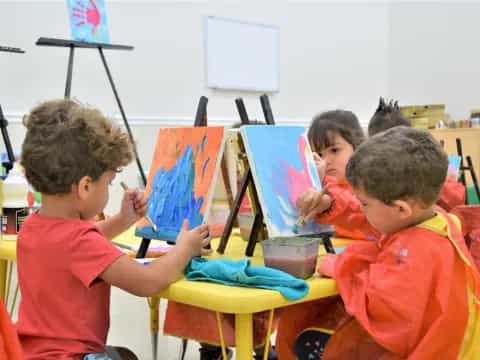 a group of children painting