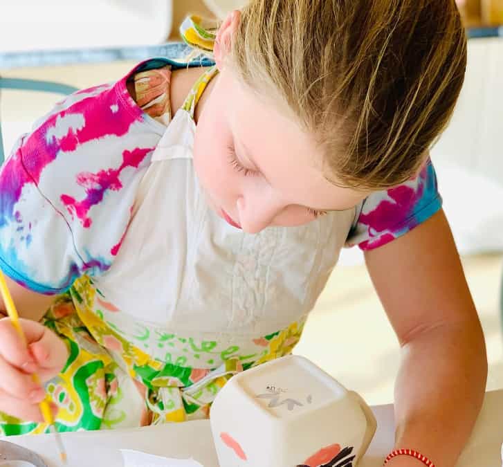 a young girl coloring on a book