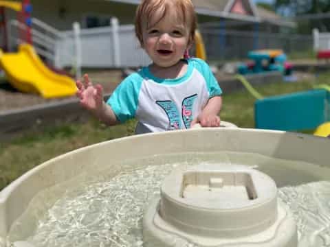 a child playing in a sand pit
