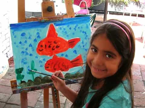 a girl holding a painting
