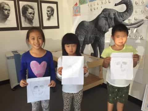 a group of children holding papers