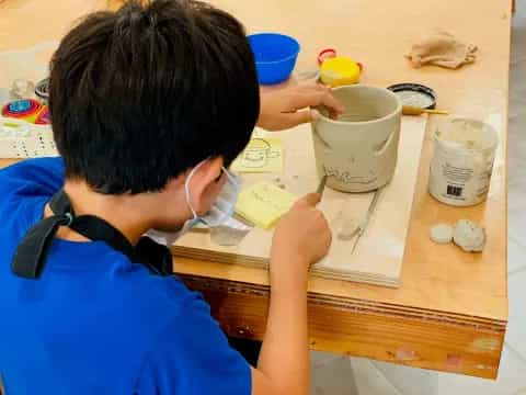 a boy painting on a table