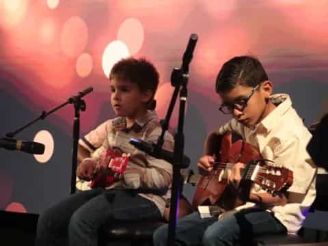 a couple of men playing guitars