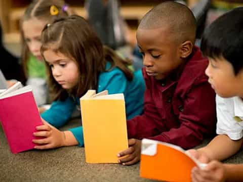 a group of children reading books