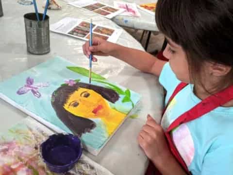 a child painting on a table