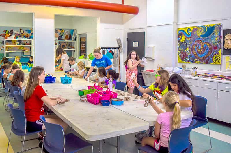 a group of children sitting around a table