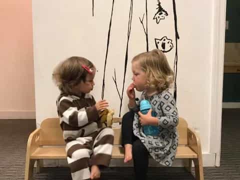 two children sitting on chairs