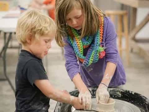 a person and a boy making a cake