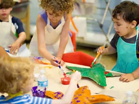 a group of children painting