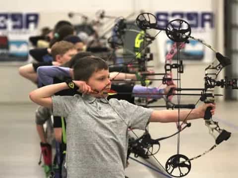 a boy holding a bicycle