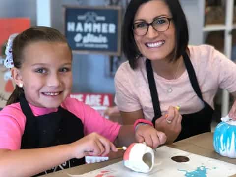 a woman and a girl painting