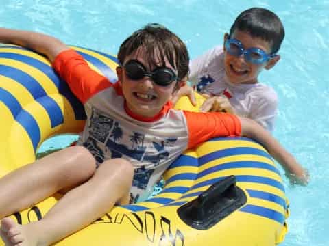 a couple of boys in a pool