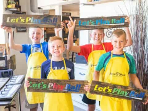 a group of boys holding up a sign