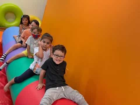 a group of people sitting on a slide