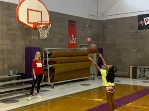 a group of women playing basketball