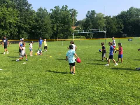 a group of kids playing football
