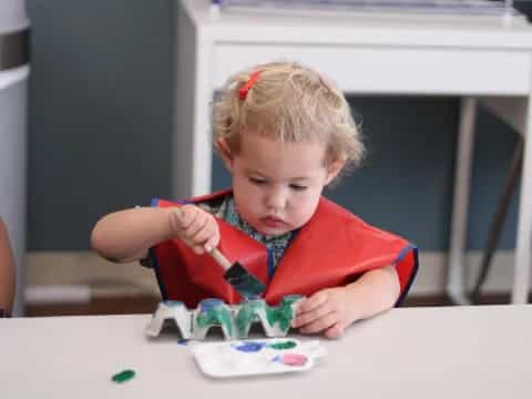 a child painting on a table