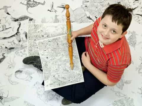 a boy holding a pencil