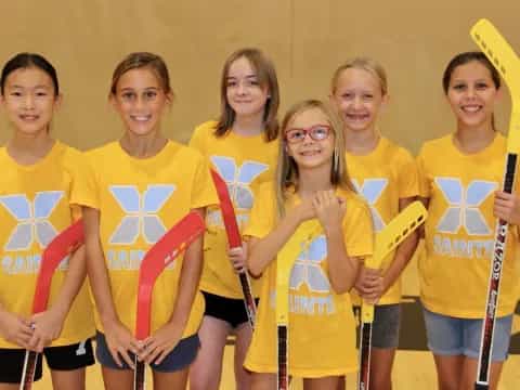 a group of girls wearing yellow shirts