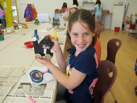 a girl holding a toy