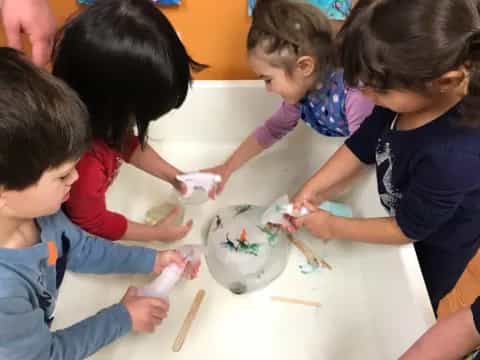 a group of children painting