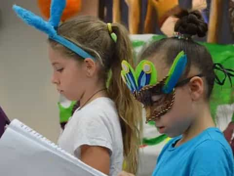 a group of girls wearing colorful hats