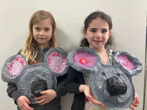 girls holding a stuffed animal