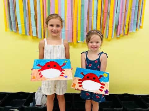 two girls holding stuffed animals
