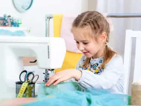 a little girl using a computer