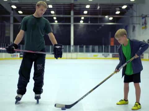 a couple of men playing hockey