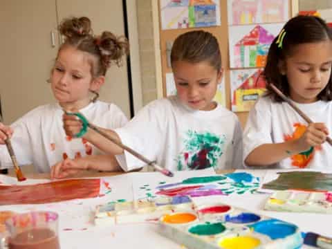 a group of children painting
