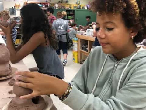 a person cutting a cake