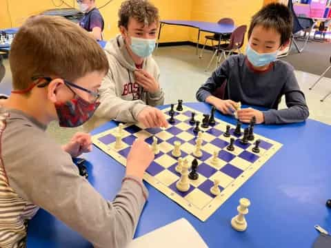 a group of boys playing chess