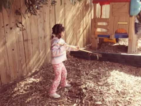a girl holding a stick