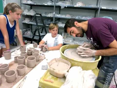 a man and a woman making pottery