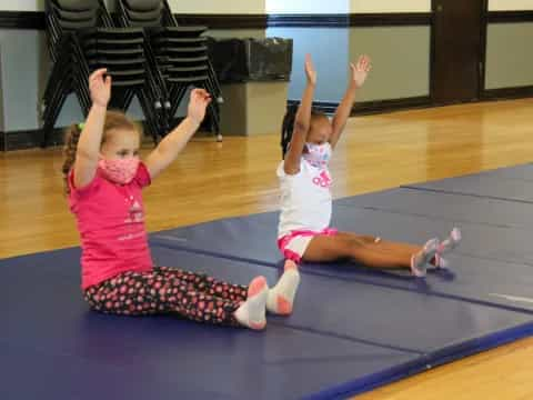 a couple of girls doing yoga