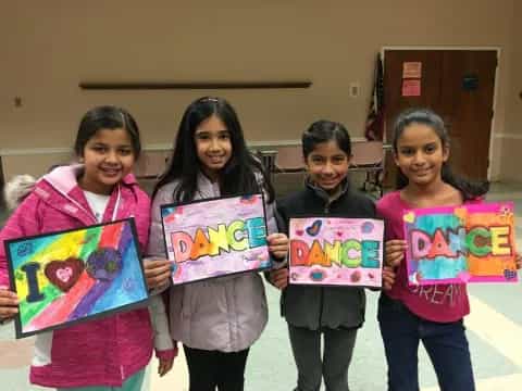 a group of girls holding signs