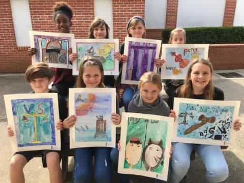 a group of children holding books