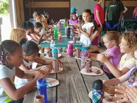a group of children eating at a table