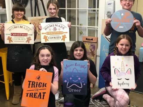 a group of kids holding signs