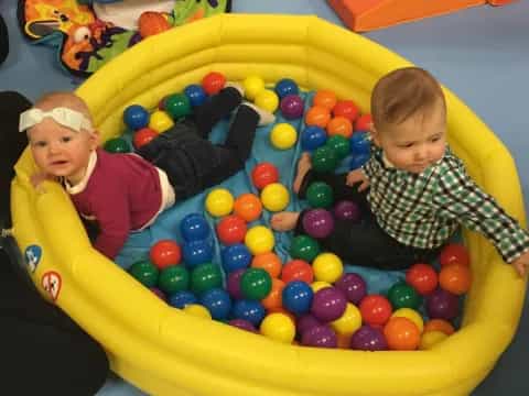 two boys in a ball pit