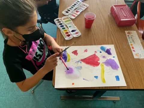 a girl painting on a table
