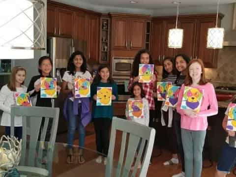 a group of girls holding signs