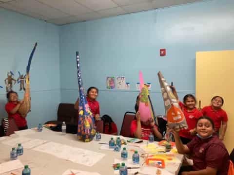 a group of kids in red shirts