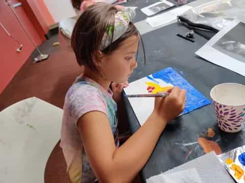 a girl painting on a table