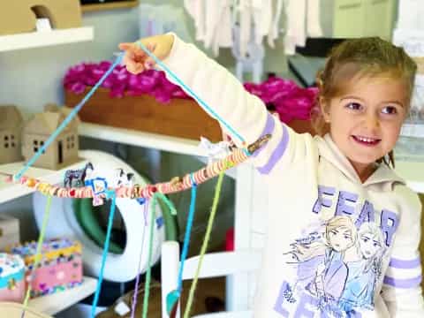 a young girl holding a toy