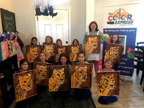 a group of children holding up posters