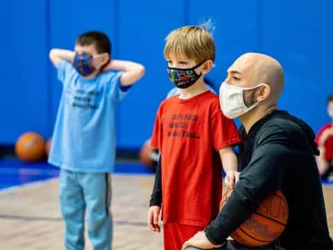 a group of boys wearing masks